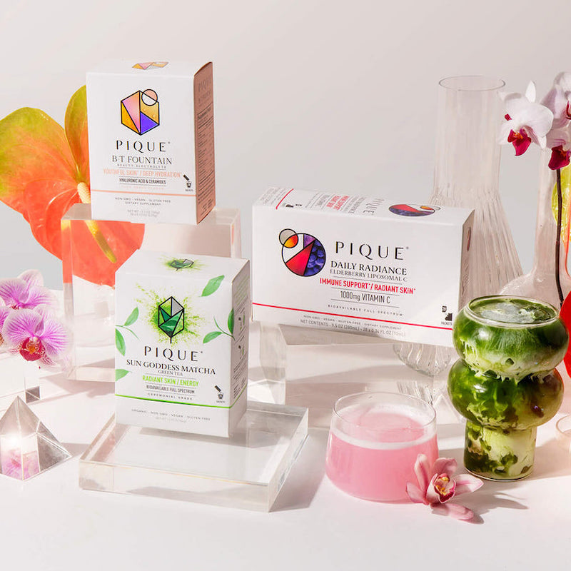 pique tea vegan brand photo with different, colorful teas in boxes and in glasses